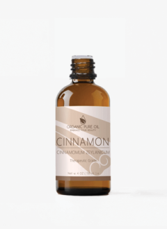 cinnamon essential oil surrounded by cinnamon sticks and dried cinnamon bark